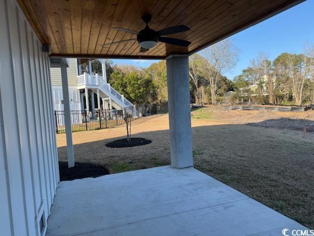 view of yard featuring a patio, stairway, fence, and ceiling fan