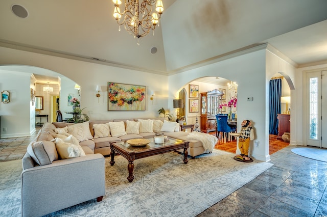 living room featuring an inviting chandelier, a towering ceiling, and crown molding