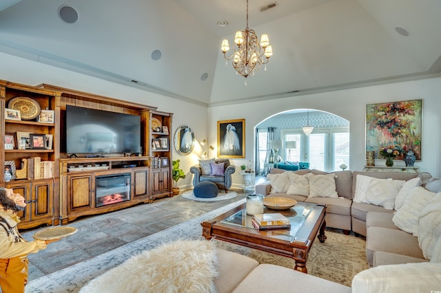 living room featuring a chandelier and high vaulted ceiling