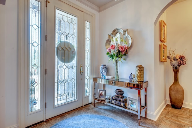 entrance foyer with plenty of natural light and ornamental molding