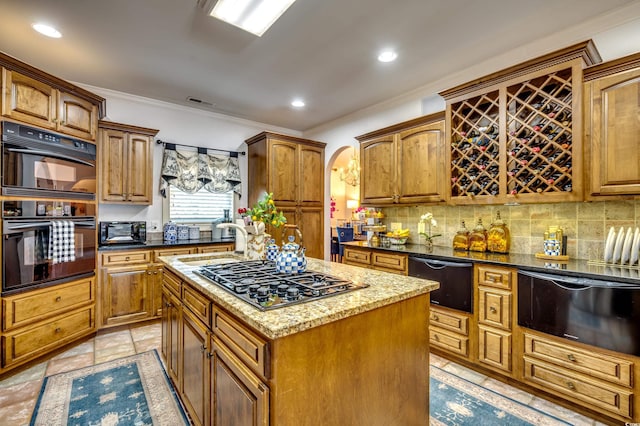 kitchen with sink, tasteful backsplash, crown molding, a kitchen island, and black appliances