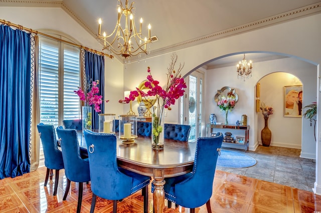 dining area with lofted ceiling, a healthy amount of sunlight, and an inviting chandelier