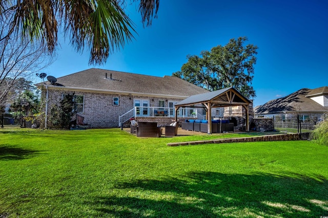 back of property with a gazebo, an outdoor hangout area, and a lawn