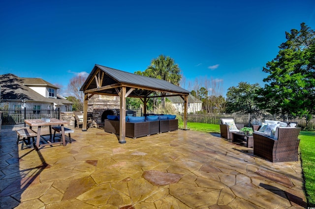 view of patio with a gazebo and an outdoor living space with a fireplace