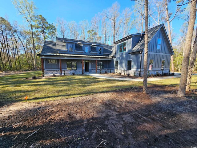 view of front of house featuring roof with shingles, board and batten siding, and stone siding