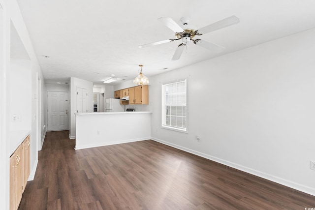 unfurnished living room with ceiling fan and dark hardwood / wood-style floors