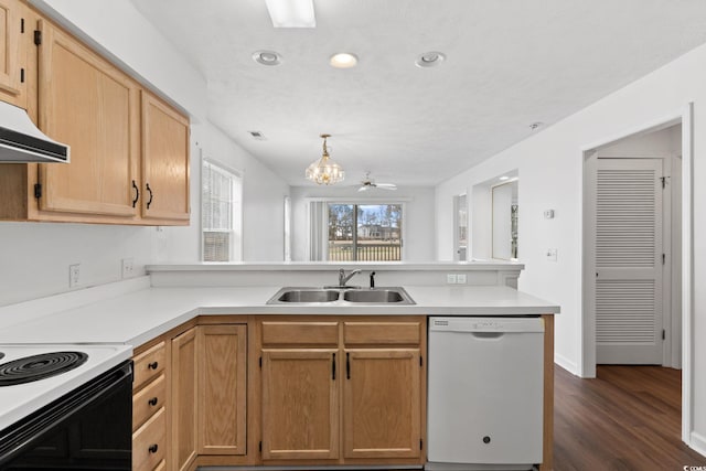 kitchen with sink, dishwasher, hanging light fixtures, light brown cabinetry, and kitchen peninsula