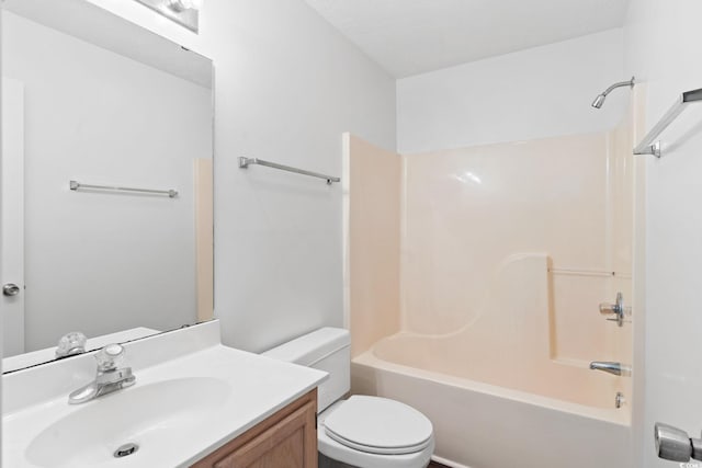 full bathroom featuring washtub / shower combination, vanity, and toilet