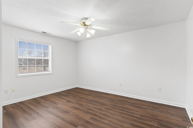 unfurnished room featuring dark wood-type flooring and ceiling fan