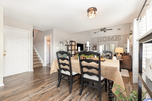 dining area with stairs, a ceiling fan, baseboards, and wood finished floors