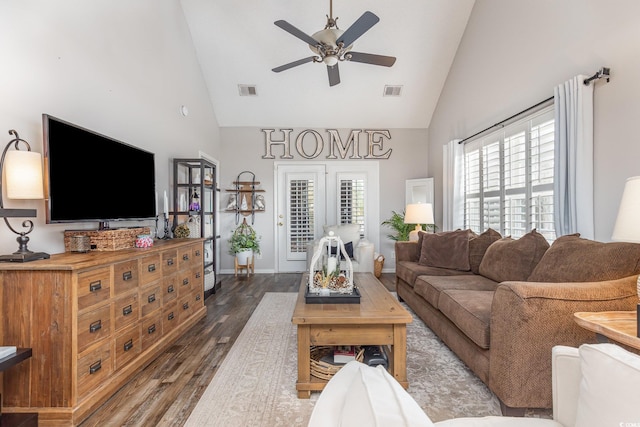 living area featuring a ceiling fan, high vaulted ceiling, visible vents, and wood finished floors