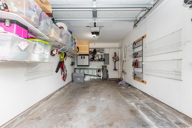 garage featuring a garage door opener and electric panel