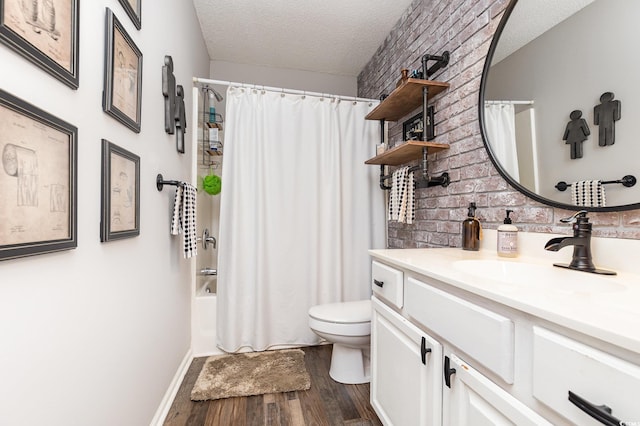 full bath with a textured ceiling, shower / bath combination with curtain, wood finished floors, vanity, and toilet