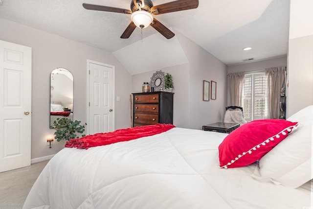 bedroom with carpet floors, visible vents, lofted ceiling, baseboards, and ceiling fan