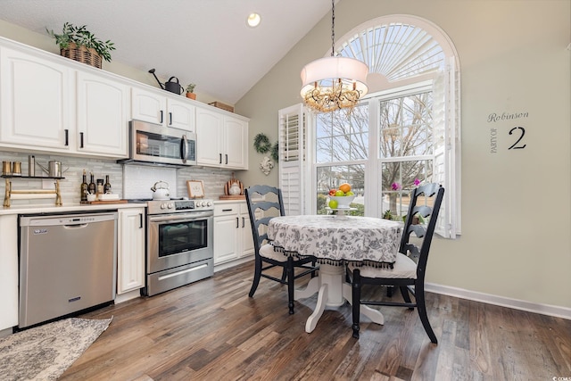 kitchen featuring white cabinetry, backsplash, a notable chandelier, and stainless steel appliances