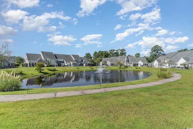 surrounding community with a residential view, a water view, and a lawn