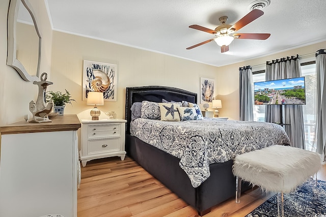 bedroom with light wood-type flooring, ornamental molding, access to outside, ceiling fan, and a textured ceiling