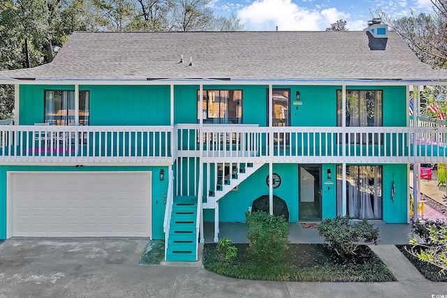 view of property with a garage and covered porch