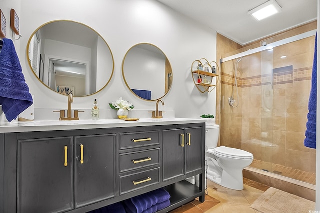 bathroom featuring tile patterned floors, toilet, a shower with door, and vanity