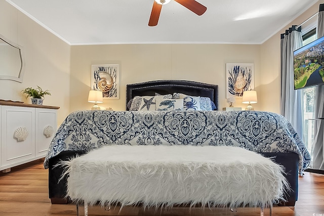 bedroom featuring ornamental molding, hardwood / wood-style floors, and ceiling fan