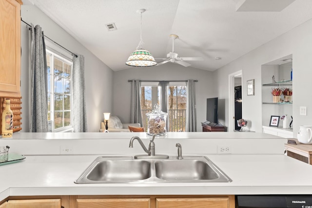 kitchen with sink, vaulted ceiling, light brown cabinets, dishwashing machine, and ceiling fan