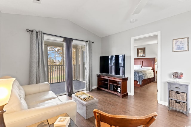 living room featuring ceiling fan, lofted ceiling, and dark hardwood / wood-style flooring