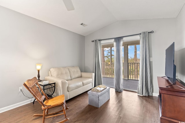 living room with dark wood-type flooring, ceiling fan, and vaulted ceiling