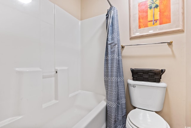 bathroom featuring shower / bath combo and toilet