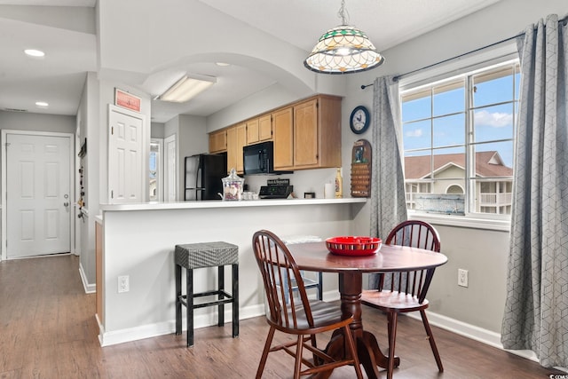 dining space with hardwood / wood-style flooring