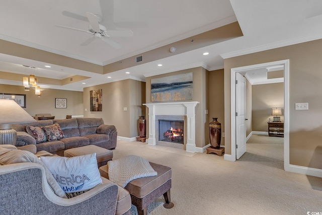 living area featuring light colored carpet, ornamental molding, a ceiling fan, and visible vents