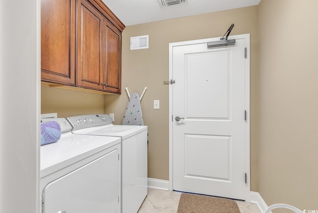laundry room featuring visible vents, cabinet space, light tile patterned floors, baseboards, and washer and dryer