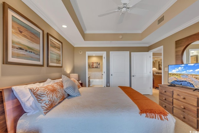 bedroom featuring visible vents, ornamental molding, recessed lighting, a raised ceiling, and ensuite bath