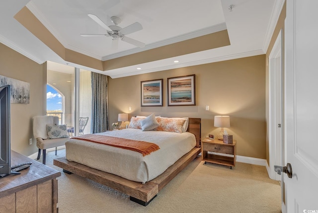 bedroom featuring crown molding, a raised ceiling, baseboards, and light carpet
