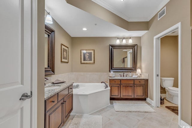 full bathroom with a garden tub, a sink, two vanities, and visible vents