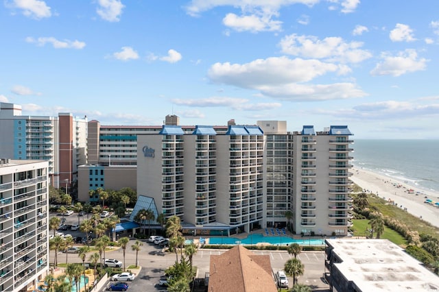 view of property with a beach view and a water view