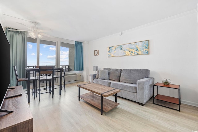 living room featuring ceiling fan, ornamental molding, and light hardwood / wood-style floors