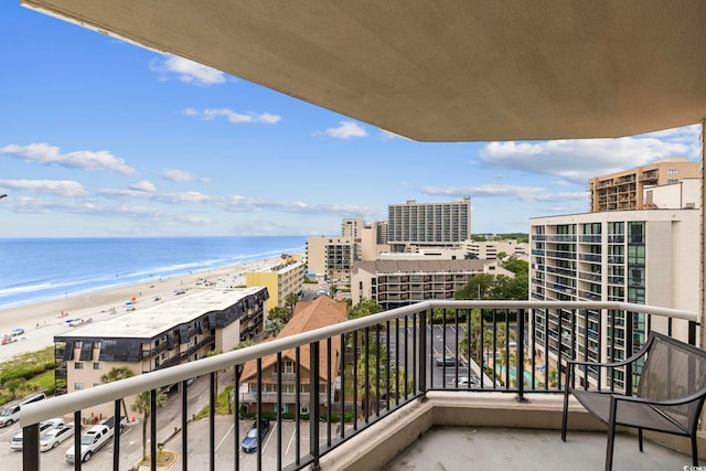 balcony featuring a view of the beach and a water view