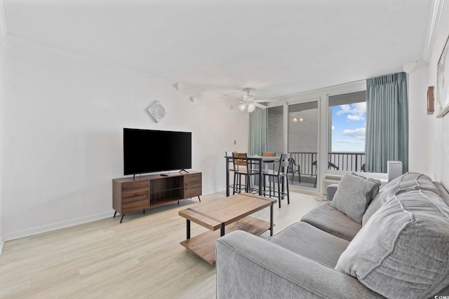 living room with ceiling fan and light hardwood / wood-style floors