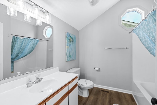 full bathroom featuring lofted ceiling, toilet, hardwood / wood-style floors, and a wealth of natural light