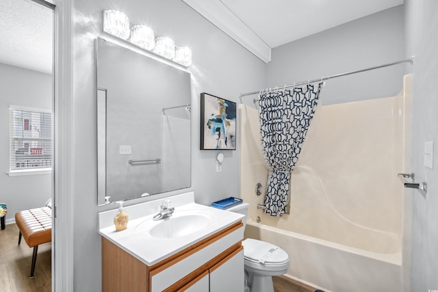 full bathroom with toilet, a textured ceiling, hardwood / wood-style flooring, vanity, and shower / bath combination with curtain