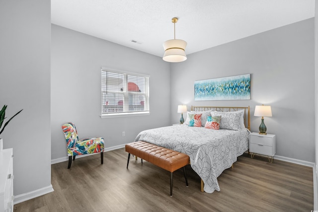 bedroom featuring dark hardwood / wood-style flooring