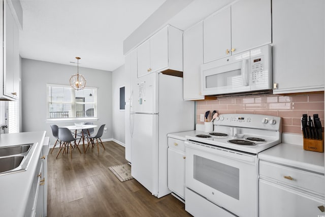 kitchen featuring white appliances, decorative light fixtures, decorative backsplash, and white cabinets