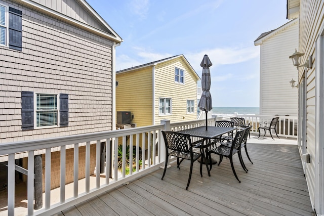 wooden deck featuring a water view and central AC unit