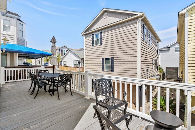 wooden deck featuring central AC unit