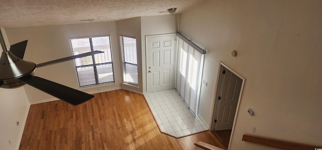 foyer featuring a textured ceiling and light hardwood / wood-style flooring