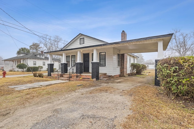 view of front of home featuring a carport and a porch