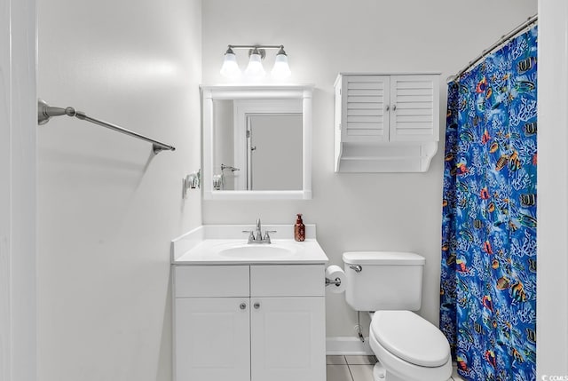 bathroom featuring tile patterned floors, vanity, and toilet