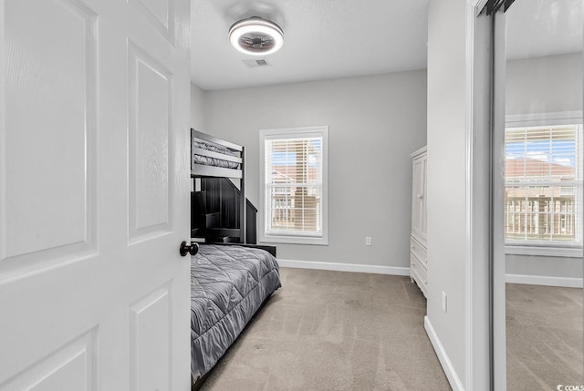 bedroom featuring light carpet and a textured ceiling