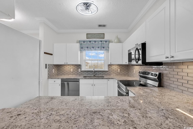 kitchen featuring white cabinetry, appliances with stainless steel finishes, sink, and light stone counters