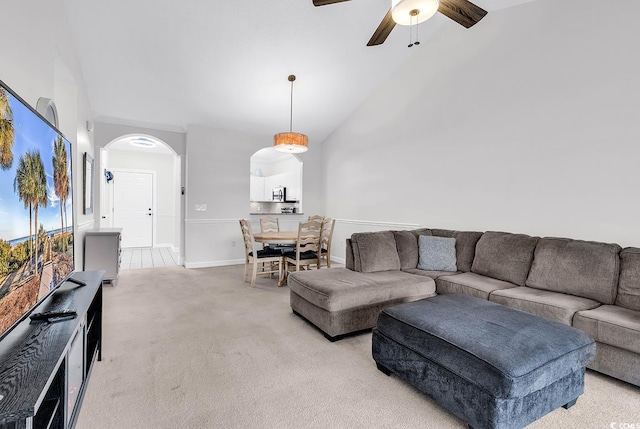 carpeted living room featuring ceiling fan and high vaulted ceiling